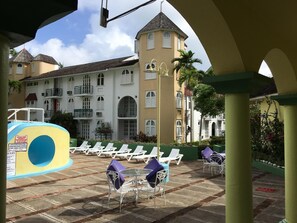 Resort loungers and seating area set by the pool