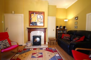 Cosy sitting room with TV and woodburning effect stove