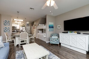 Open concept living area with queen size credenza bed and coastal features through out
