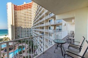 Step out onto your large private balcony and enjoy the view of the pool and the beach.