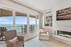 Sliding glass door to oversized balcony - In cooler months, enjoy the spectacular gas fireplace and all year long, enjoy the dry bar by the sliding glass doors to your view of the gulf.