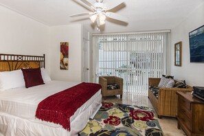 Queen Bedroom with Seating Area and Ceiling Fan