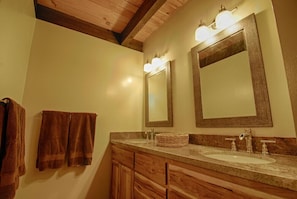 Full bathroom downstairs; double sink vanity area