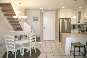 view from the living area into the kitchen and dining area