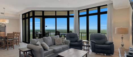 Spacious Living and Dining Areas with floor to ceiling windows reveal a fantastic view of paradise