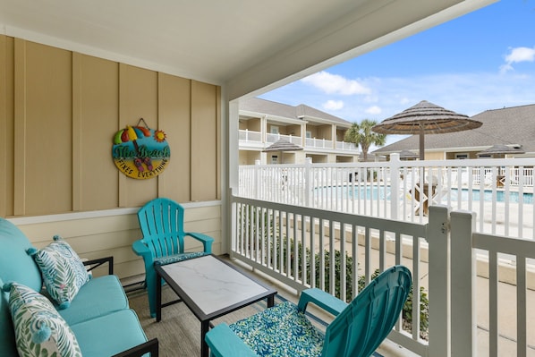 Private patio with new cozy cushions to relax on and a view of the pool