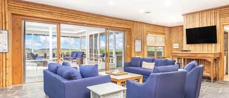 Living Room with sliding glass doors that open to the large screened porch