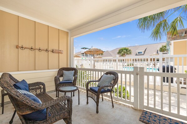 Relax on your private patio with a poolside view