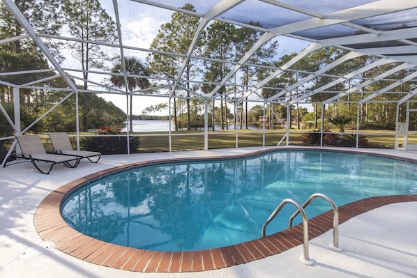 Screened in large pool with lake view