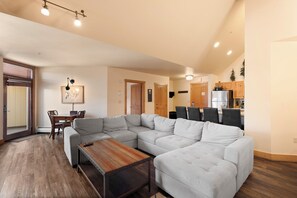 Spacious living room with a mounted TV, gas fireplace, queen sleeper sofa, and queen Murphy bed.