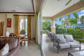 Large windows allow natural light to fill the interior of the condo, connecting the tranquil outdoor space with the comfortable.