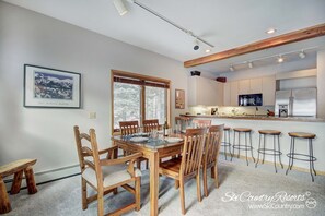 Dining Room / Kitchen - Gather around the wooden dining room table, comfortably seating six (w/ extra chair for 1). Enjoy meals together & engage in lively conversations while overlooking the open concept kitchen.