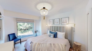 Bright and airy primary bedroom with king sized bed