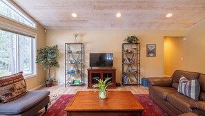 Living Room w/ Entertainment Center: Three Pines Family Cabin