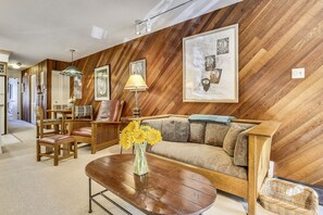 Living, dining and kitchen space with Murphy bed stored