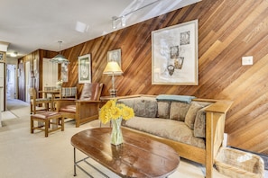 Living, dining and kitchen space with Murphy bed stored