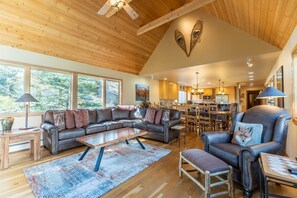 Living area featuring new cozy furnishings and a wood-burning fireplace.
