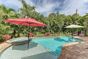 Large pool has tanning deck, swim up bar and spa