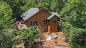 Moose Tracks has wonderful outdoor spaces including wrap-around Upper Deck, Ground Level large covered Patio with Cornhole game, an wood burning Fire Pit area with plenty of seating.