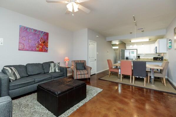 The kitchen, dining, and living areas blend together seamlessly for a bright and airy feel