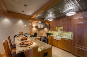 Kitchen with Breakfast Bar, Refrigerator, and Coffee Maker