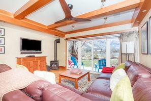 Living Area with Sofas, Ceiling Fan, Fireplace, and Smart TV