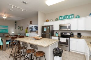 Kitchen area with beautiful counter tops and ample storage space