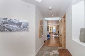 Front door and elevator foyer. Hallway with numerous skylights bathe this rooftop penthouse with natural light.