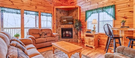 Welcome to Hawks Point Lodge - A towering cathedral ceiling, huge windows letting in plenty of sunshine, a stone-surround electric fireplace, a 55” TV with satellite channels and a DVD player: What a great space for hanging out with family and friends.