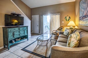 Living Area - The living area offers a sleeper sofa, side chair, television stand with television