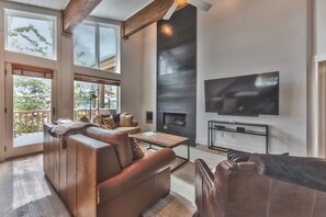 Living Room with a Gas Fireplace, a 70" Sony Smart TV, and Queen Sofa Sleeper