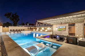 Sunken Bar has 2 fridges, ice maker, grill, 65" flat screen TV.