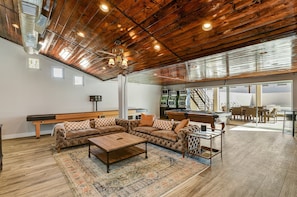 The Living Room / Game Room with 85" tv, 16' Shuffleboard Table, and 8' pool table.