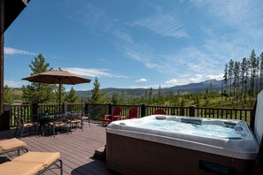 A bubbling hot tub with mountain views awaits