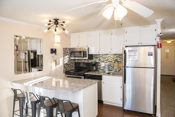 Entertain and relax in style in our spacious living area featuring a fully equipped kitchen, perfect for hosting friends and family during your stay.