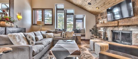 Upper Level Living Room with Cozy Mountain Contemporary Furnishings, a Smart TV and a Gas Assist Wood Fireplace