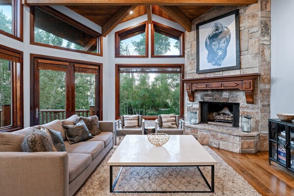 Living Room flooded with natural light, fireplace, and mountain-modern furnishings.