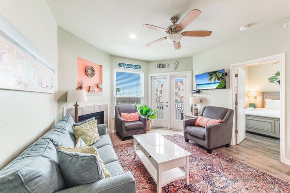 Charming living space with cozy seating throughout and coastal beach vibes