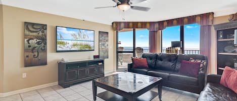 Spacious Living Room with New Furniture offers Comfortable Seating, Beachfront Views and Balcony Access