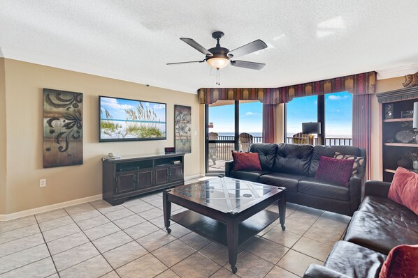 Spacious Living Room with New Furniture offers Comfortable Seating, Beachfront Views and Balcony Access