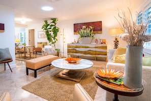 A vacation feel is seen in this room with pops of green and orange