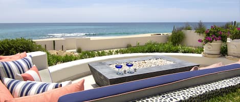 Patio with firepit and an beachfront view