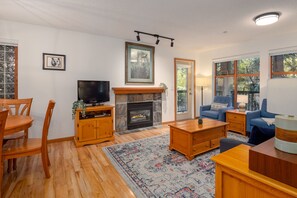 Open concept living area with gas fireplace and TV