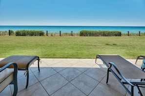 Adagio A102 patio - Enjoy the patio overlooking the gulf while the children play on the grassy area in front. You are steps to the gulf front pool and the beach walkover - but not close to the crowds at Adagio A102.