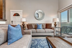 New living room with 60" HD LED Smart TV, Sonos surround sound, gas fireplace, plush seating, and private deck with BBQ grill