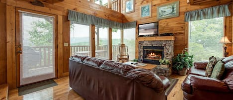 Welcome to Mountain Seduction - Large leather couches, a stone-surround fireplace, HDTV with cable, large windows with views of the woods and the mountains: There’s a lot to love about Mountain Seduction’s great room.