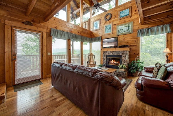 Welcome to Mountain Seduction - Large leather couches, a stone-surround fireplace, HDTV with cable, large windows with views of the woods and the mountains: There’s a lot to love about Mountain Seduction’s great room.