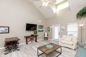 Living and dining area with comfy furniture and new flooring throughout