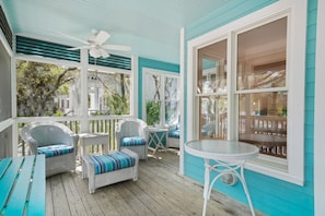 GENEROUS FURNISHED SCREENED FRONT PORCH AT ENTRANCE