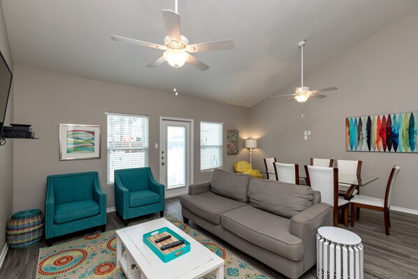 Luxurious open-concept living space featuring contemporary furnishings and bathed in natural light